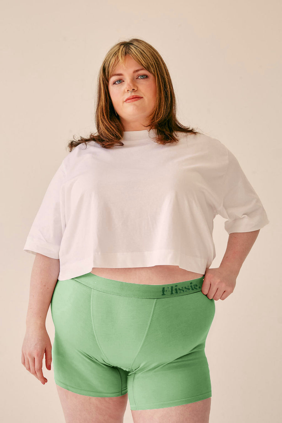 Model wearing Flissie women's bamboo boxer shorts in sage green with a white T-shirt